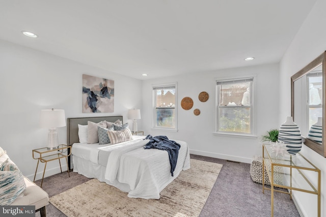 carpeted bedroom featuring baseboards, visible vents, and recessed lighting