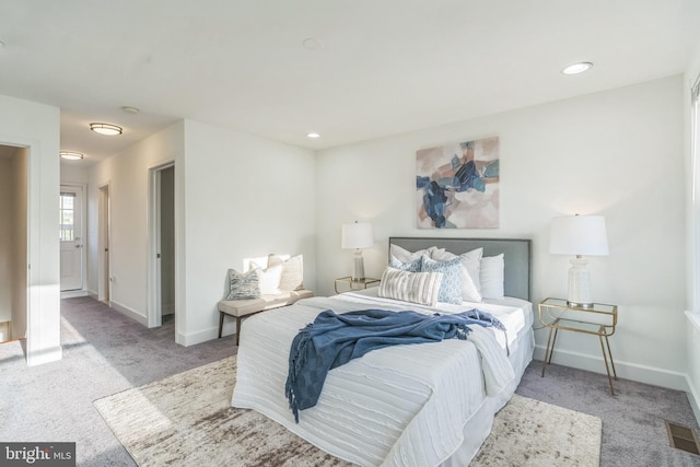 carpeted bedroom with recessed lighting, visible vents, and baseboards