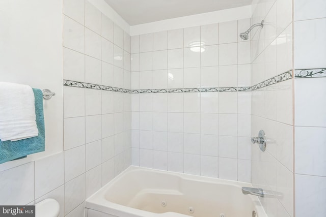full bathroom featuring toilet and a combined bath / shower with jetted tub