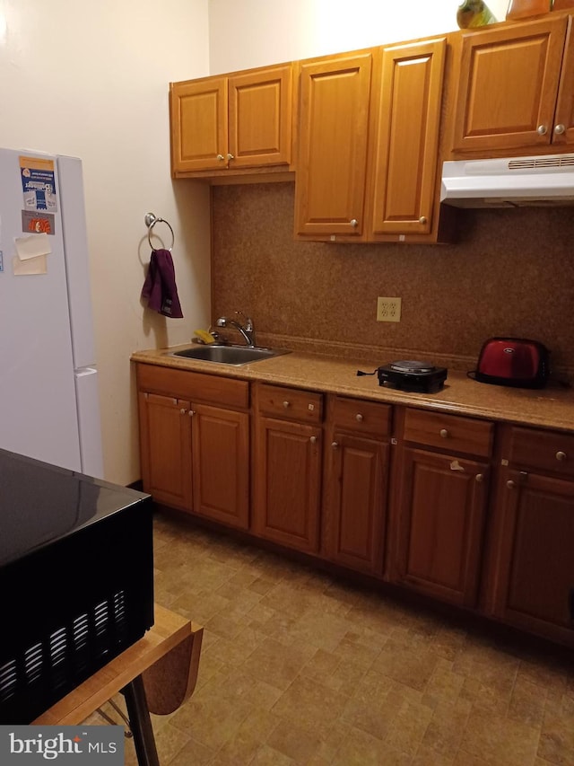 120 Arch St, Catasauqua, PA 18032 - kitchen featuring a sink, light countertops, freestanding refrigerator, under cabinet range hood, and decorative backsplash