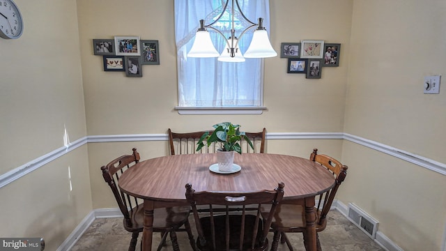 dining area featuring stone finish floor, visible vents, and baseboards