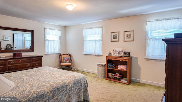 bedroom featuring carpet floors and baseboards