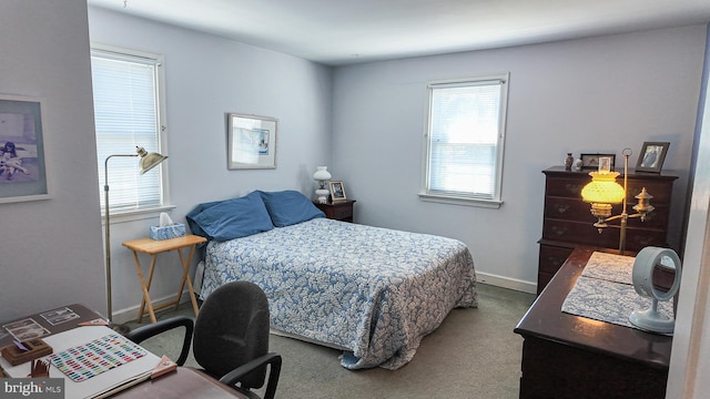 carpeted bedroom featuring baseboards