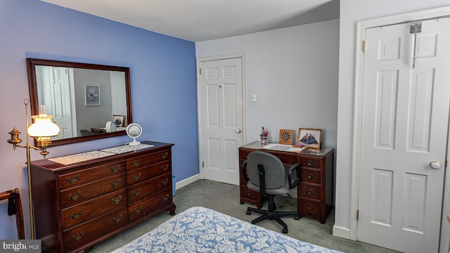 bedroom featuring dark carpet and baseboards