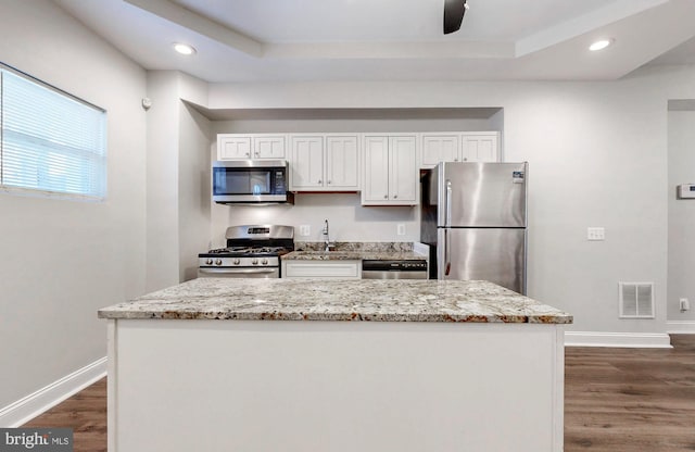 kitchen featuring visible vents, baseboards, white cabinets, stainless steel appliances, and dark wood-type flooring
