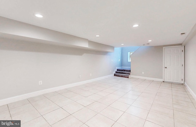 below grade area with recessed lighting, stairway, baseboards, and light tile patterned flooring