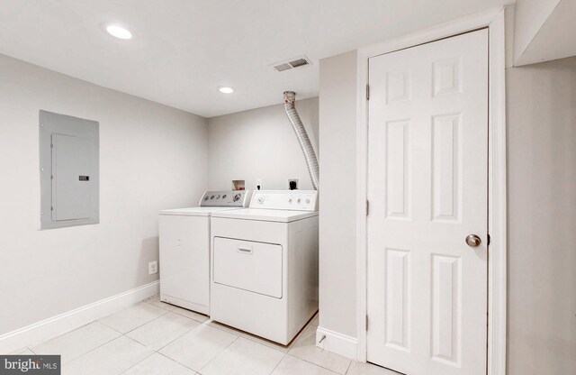 laundry room featuring visible vents, baseboards, separate washer and dryer, electric panel, and laundry area