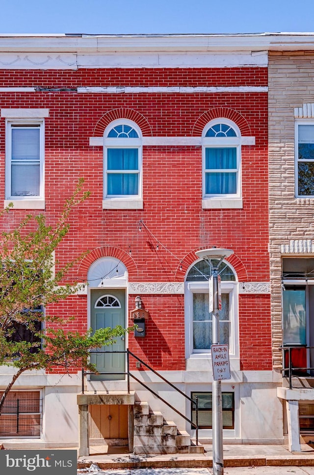 townhome / multi-family property with brick siding