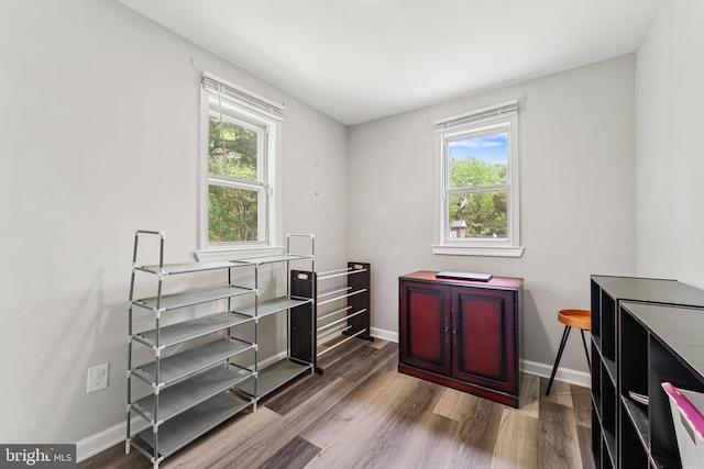interior space with wood finished floors and baseboards