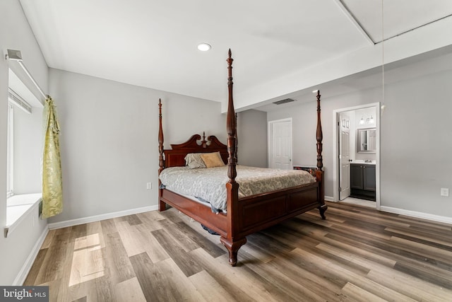 bedroom featuring attic access, recessed lighting, visible vents, baseboards, and wood finished floors