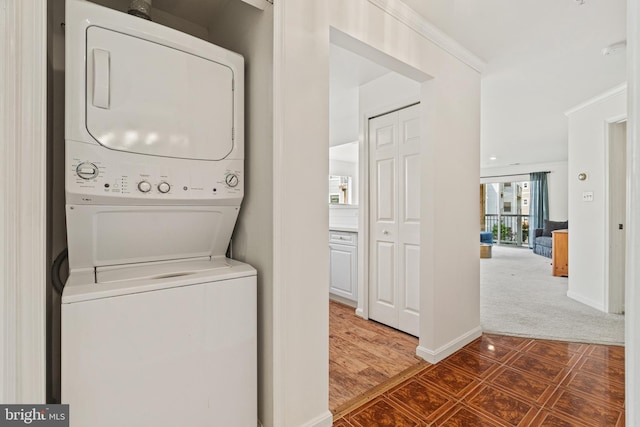 20605 Cornstalk Ter Unit 201, Ashburn, VA 20147 - clothes washing area with laundry area, carpet, baseboards, and stacked washer / dryer