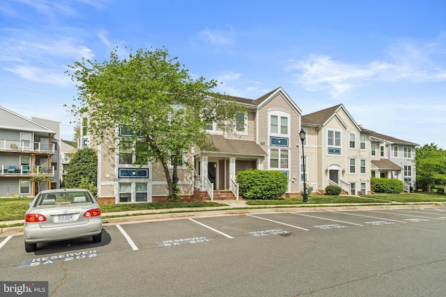 20605 Cornstalk Ter Unit 201, Ashburn, VA 20147 - view of building exterior with uncovered parking