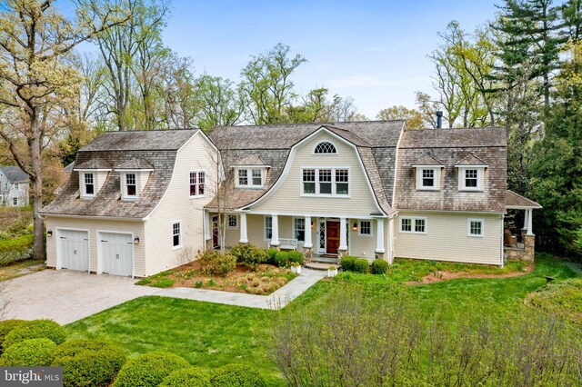 208 Wardour Dr, Annapolis, MD 21401 - shingle-style home featuring a gambrel roof, driveway, covered porch, a front yard, and a garage