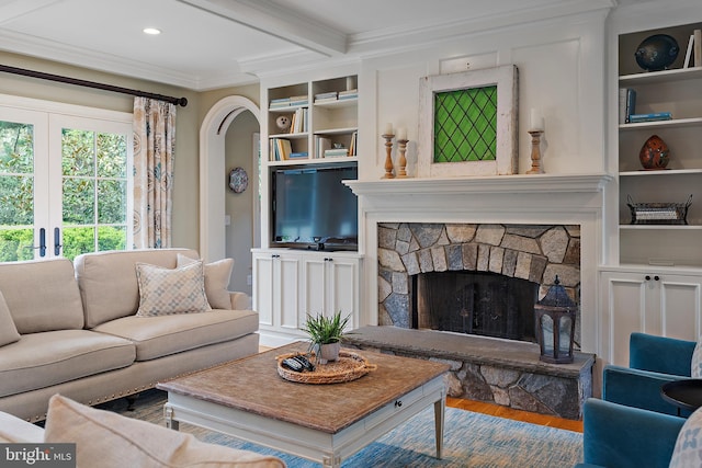 208 Wardour Dr, Annapolis, MD 21401 - living room featuring crown molding, built in features, wood finished floors, and a fireplace