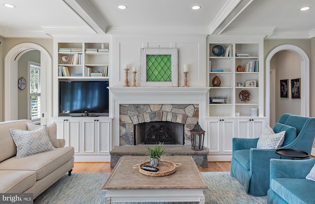 208 Wardour Dr, Annapolis, MD 21401 - living room featuring arched walkways, wood finished floors, a fireplace, and crown molding