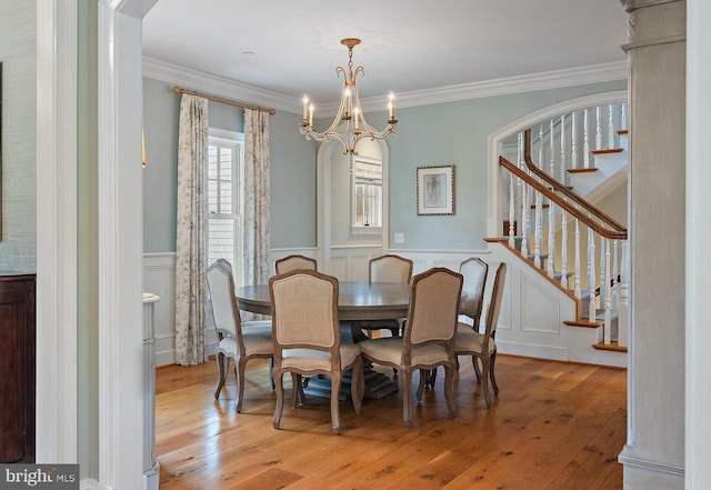 208 Wardour Dr, Annapolis, MD 21401 - dining room with stairway, a decorative wall, hardwood / wood-style flooring, wainscoting, and an inviting chandelier