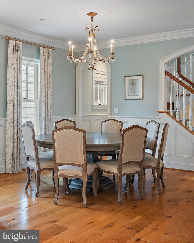208 Wardour Dr, Annapolis, MD 21401 - dining area featuring plenty of natural light, an inviting chandelier, ornamental molding, and a decorative wall
