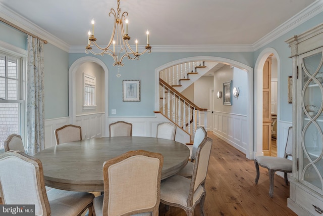 208 Wardour Dr, Annapolis, MD 21401 - dining space featuring hardwood / wood-style flooring, arched walkways, a notable chandelier, and plenty of natural light