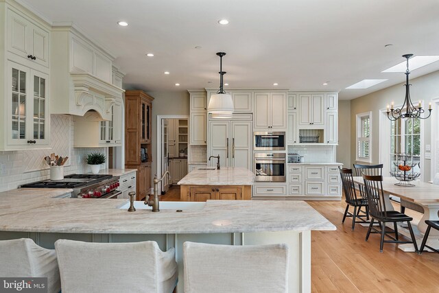 208 Wardour Dr, Annapolis, MD 21401 - kitchen featuring recessed lighting, light stone counters, stainless steel appliances, a peninsula, and tasteful backsplash