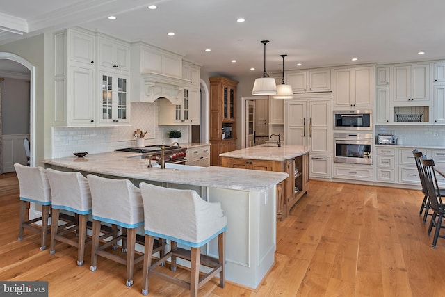 208 Wardour Dr, Annapolis, MD 21401 - kitchen with recessed lighting, light stone countertops, a peninsula, tasteful backsplash, and stainless steel oven
