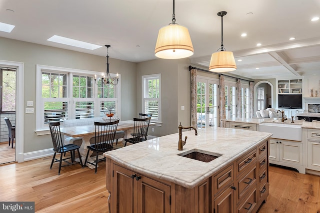 208 Wardour Dr, Annapolis, MD 21401 - kitchen featuring recessed lighting, a skylight, an island with sink, and a sink