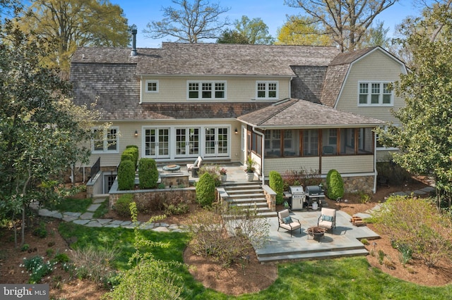 208 Wardour Dr, Annapolis, MD 21401 - back of property featuring french doors, a fire pit, a patio area, a gambrel roof, and a sunroom