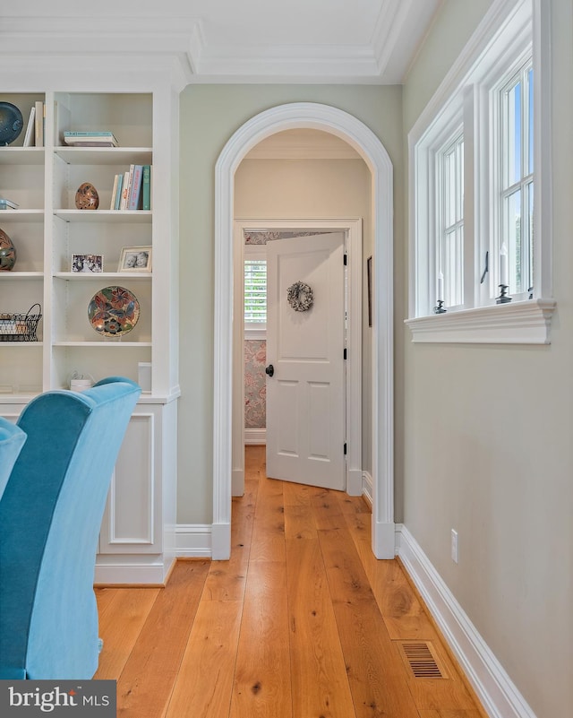 208 Wardour Dr, Annapolis, MD 21401 - hall with light wood finished floors, arched walkways, baseboards, visible vents, and crown molding