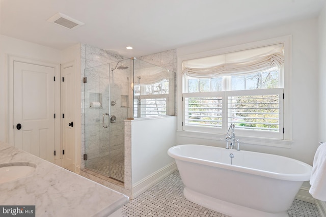 208 Wardour Dr, Annapolis, MD 21401 - full bath with a soaking tub, baseboards, visible vents, a shower stall, and vanity