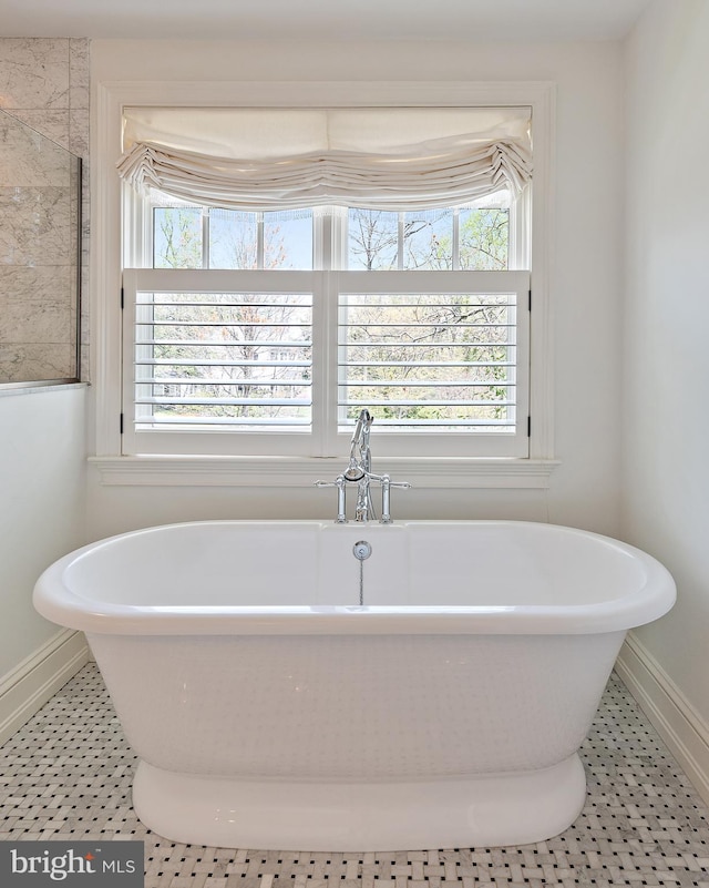208 Wardour Dr, Annapolis, MD 21401 - bathroom with a freestanding bath, a healthy amount of sunlight, and baseboards