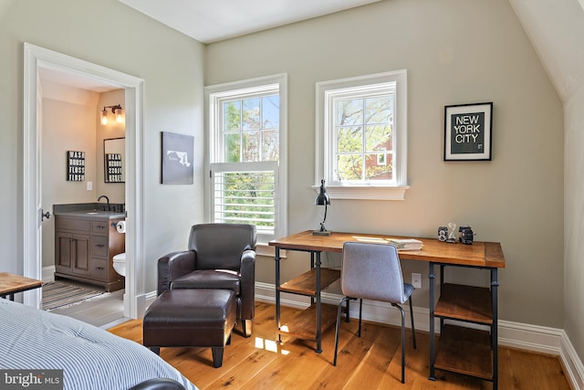 208 Wardour Dr, Annapolis, MD 21401 - bedroom with ensuite bath, baseboards, a sink, and light wood-style floors