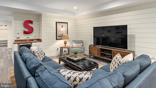 208 Wardour Dr, Annapolis, MD 21401 - living room featuring wet bar, wood walls, wood finished floors, and recessed lighting