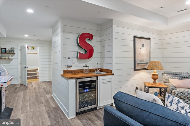 208 Wardour Dr, Annapolis, MD 21401 - bar with wet bar, visible vents, wood finished floors, wooden walls, and beverage cooler