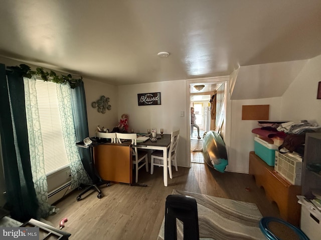 interior space with a baseboard radiator and wood finished floors
