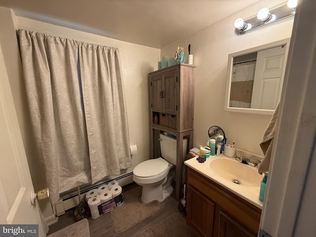 bathroom with toilet, a baseboard radiator, and vanity