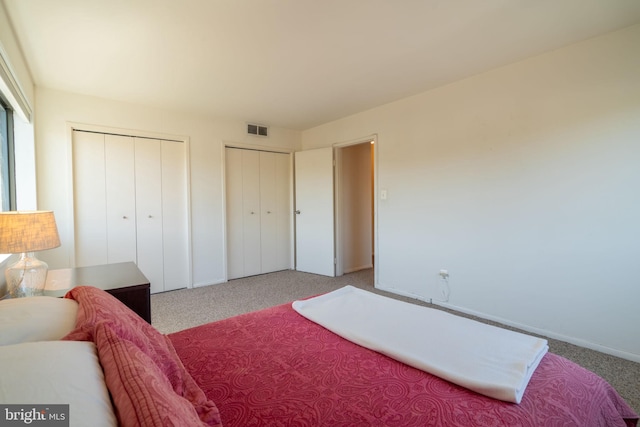 1931 N Cleveland St Unit 312, Arlington, VA 22201 - carpeted bedroom featuring baseboards, multiple closets, and visible vents