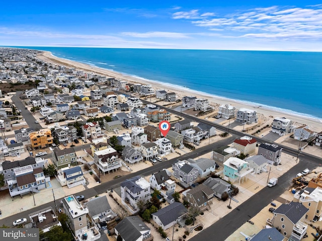drone / aerial view with a water view and a view of the beach