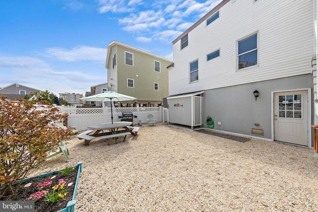 back of property featuring fence and stucco siding