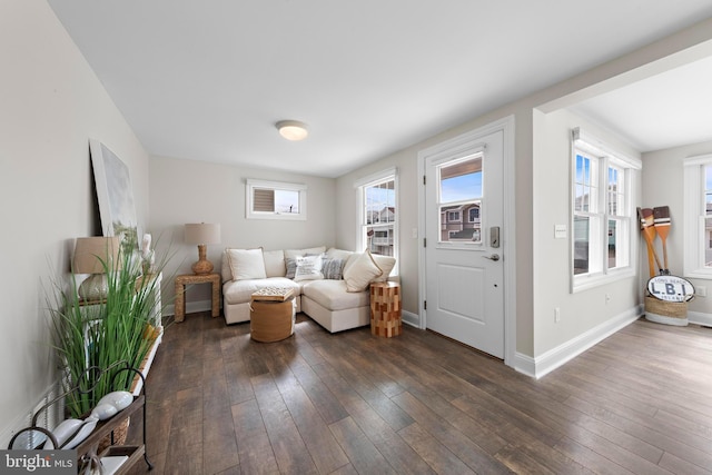 living room featuring a wealth of natural light, baseboards, and dark wood-style floors