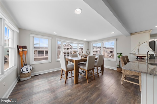 dining room with baseboards, dark wood finished floors, and recessed lighting