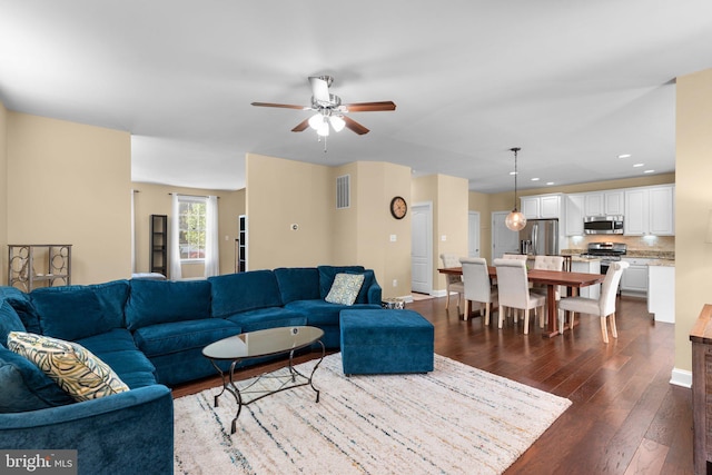 living room featuring visible vents, a ceiling fan, dark wood-style flooring, and recessed lighting