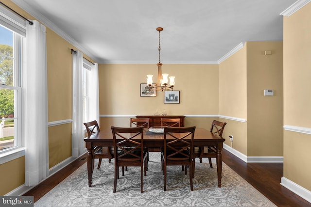 dining space featuring plenty of natural light, wood finished floors, and a chandelier