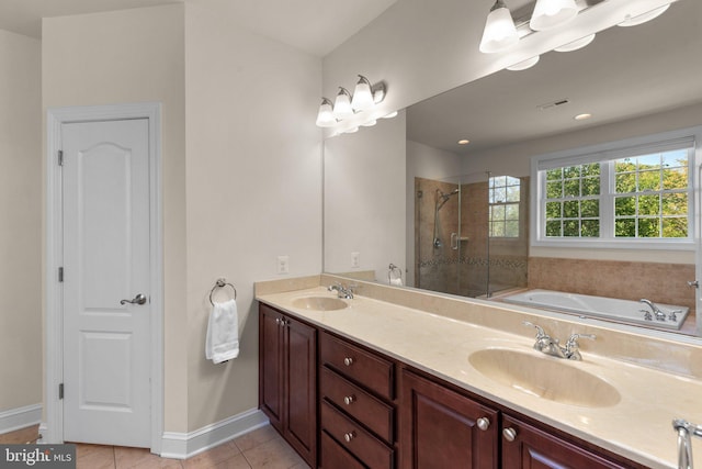 full bathroom featuring tile patterned flooring, a sink, baseboards, and a shower stall