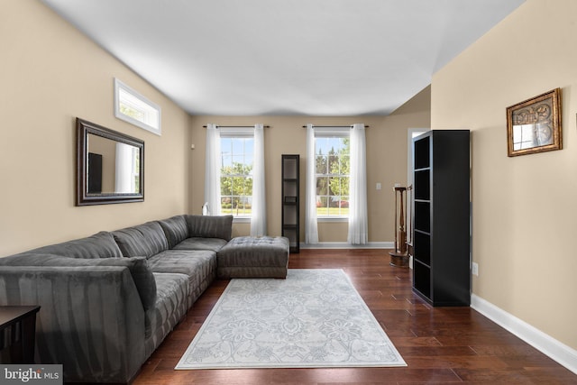 living room featuring dark wood-type flooring and baseboards