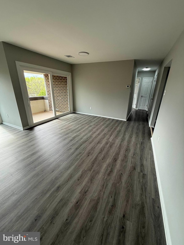 10224 Prince Pl Unit 12-307, Upper Marlboro, MD 20774 - unfurnished living room featuring baseboards, dark wood finished floors, and visible vents