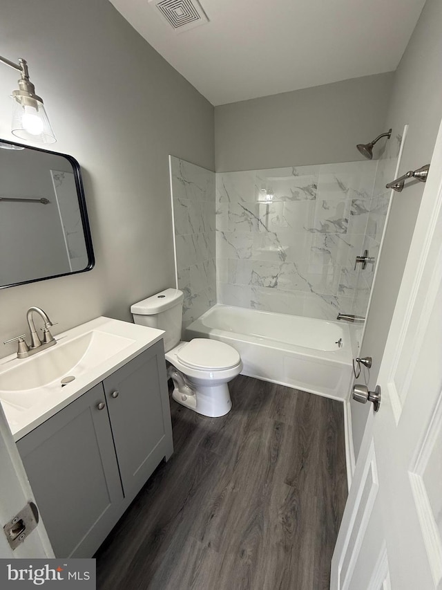 10224 Prince Pl Unit 12-307, Upper Marlboro, MD 20774 - bathroom featuring bathing tub / shower combination, vanity, visible vents, toilet, and wood finished floors