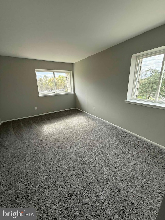 10224 Prince Pl Unit 12-307, Upper Marlboro, MD 20774 - spare room featuring baseboards and dark carpet