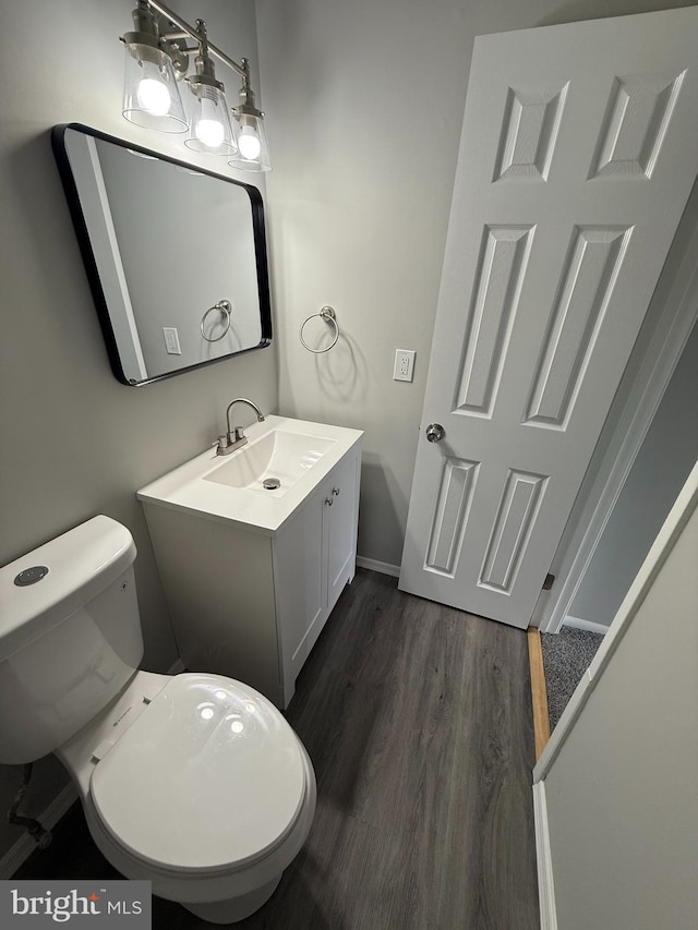 10224 Prince Pl Unit 12-307, Upper Marlboro, MD 20774 - half bath featuring toilet, vanity, wood finished floors, and baseboards