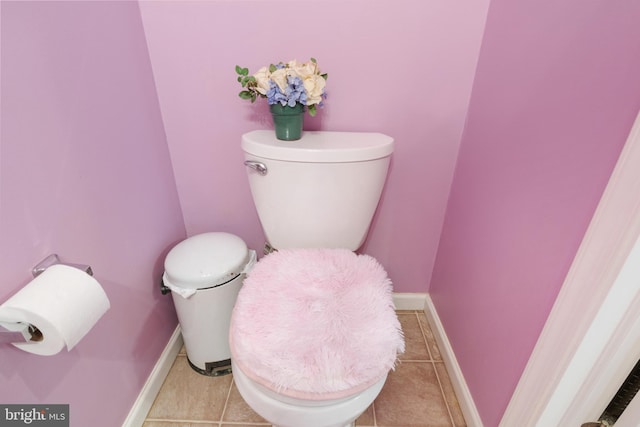 bathroom with toilet, tile patterned flooring, and baseboards