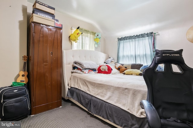 carpeted bedroom with vaulted ceiling