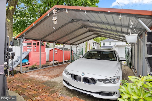 view of car parking with a carport and a storage unit